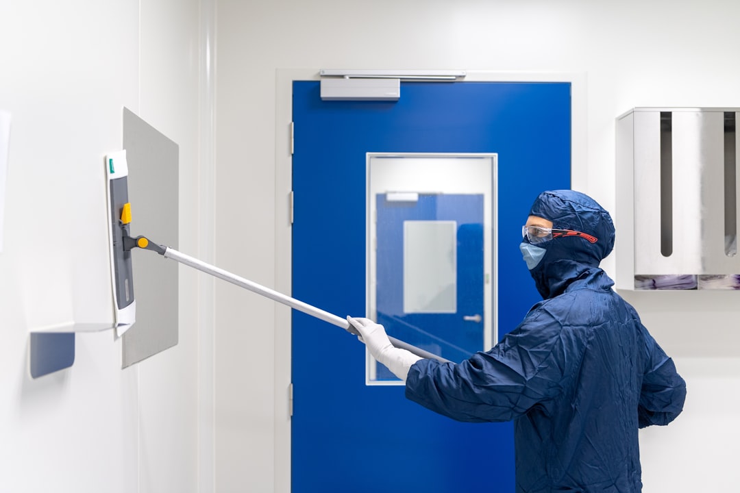Cleanroom cleaner, cleaning laboratory wall.